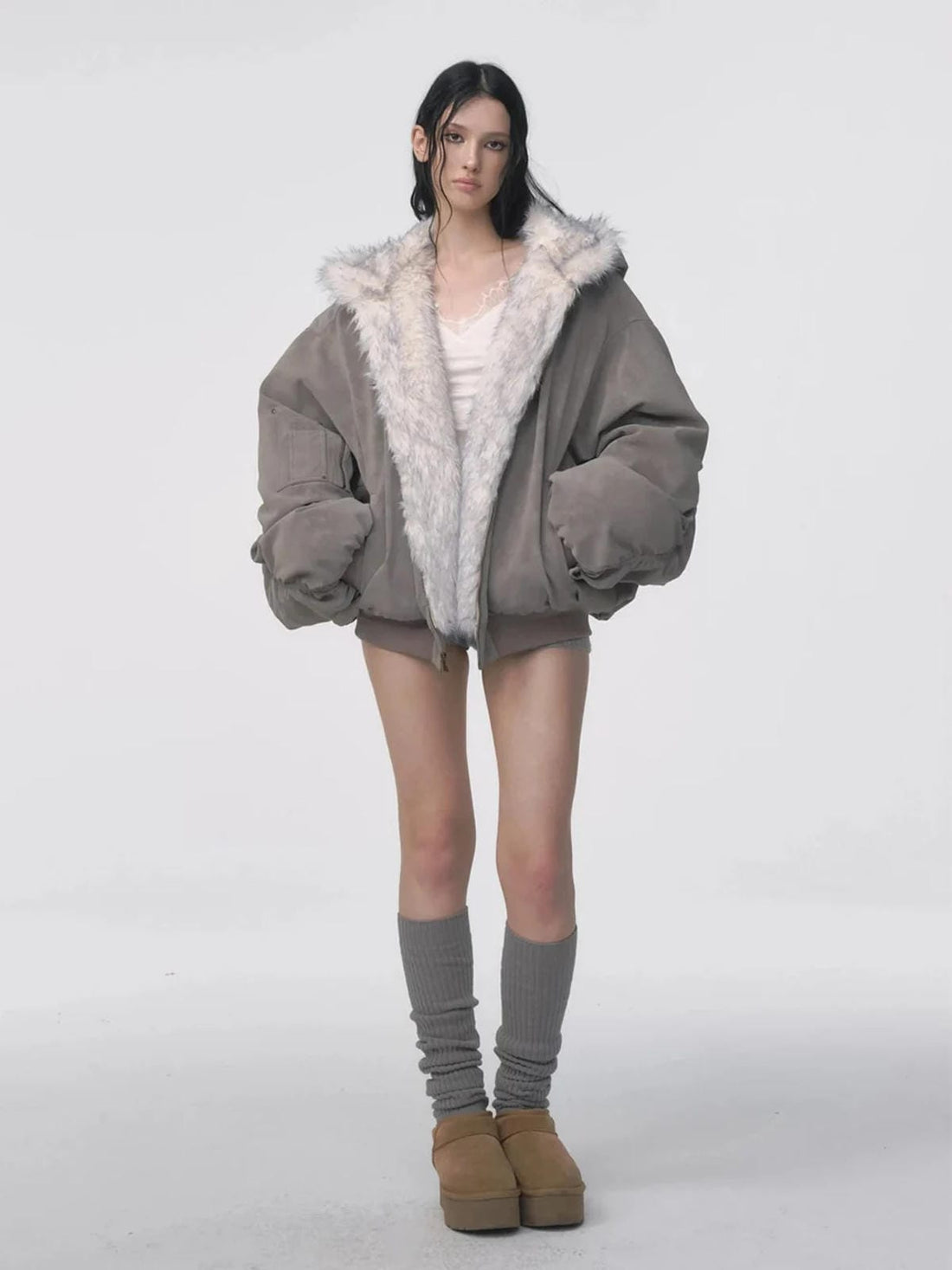 Reversible oversized hooded winter coat for women, gray padded bomber jacket side with white faux fur lining visible