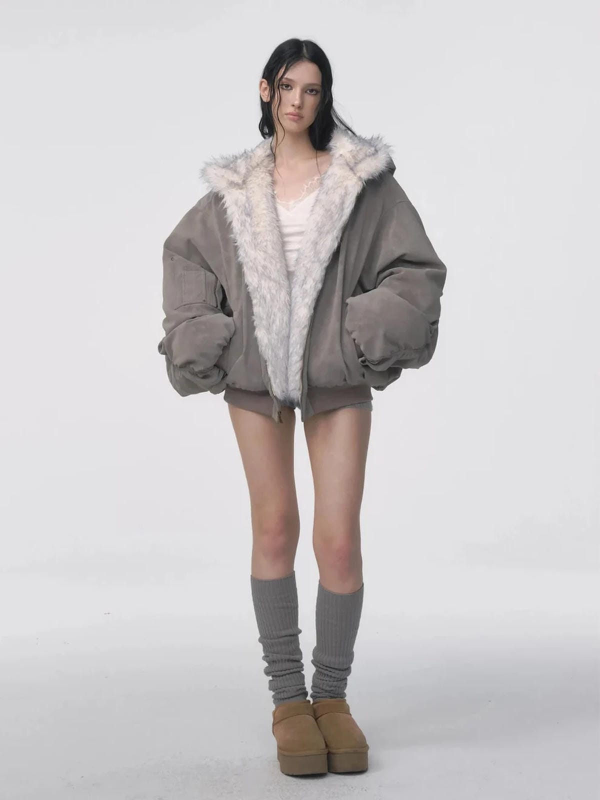 Reversible oversized hooded winter coat for women, gray padded bomber jacket side with white faux fur lining visible