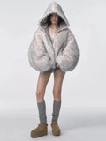 Reversible oversized hooded winter coat for women, gray padded bomber jacket side with white faux fur lining visible, styled with shorts and knee socks