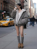Women's Reversible oversized hooded winter coat, gray padded bomber jacket side with white faux fur lining visible, styled with shorts and knee socks