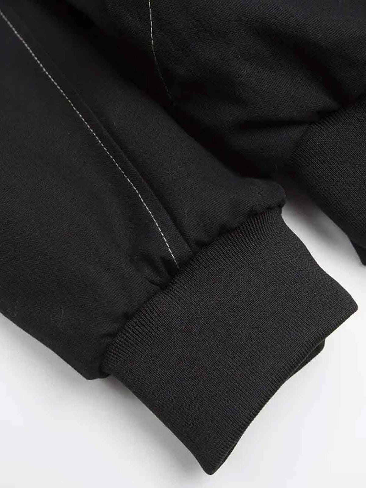 Close-up of a black jacket sleeve on a white background